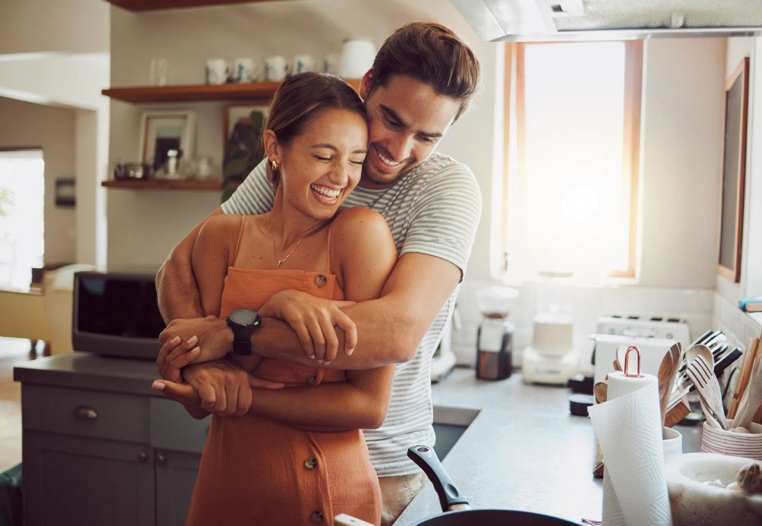 Happy couple embracing in the kitchen after reconnecting through Marriage Helper in Columbia TN