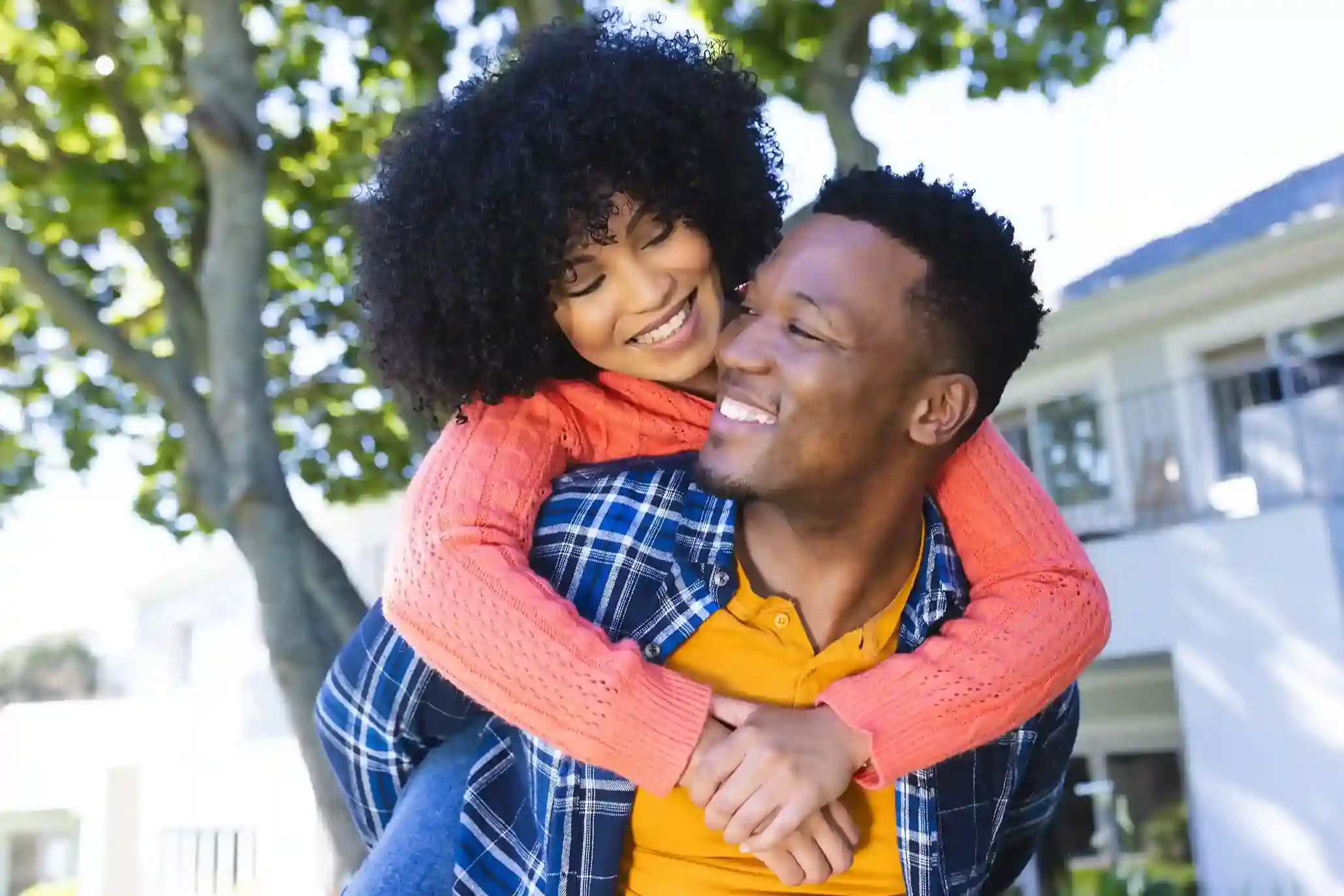 Smiling couple embracing outdoors, showing emotional connection supported by marital relationship counseling from Marriage Helper.