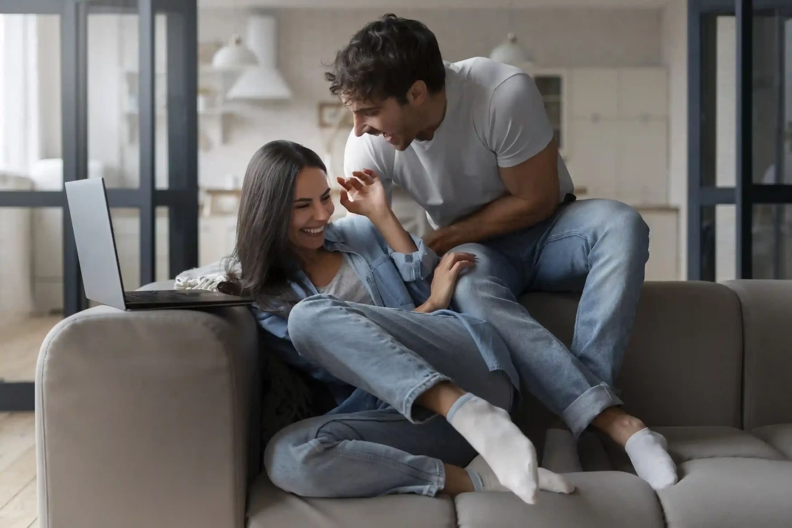 Happy couple enjoying time together at home while exploring marital relationship counseling workshop with Marriage Helper.