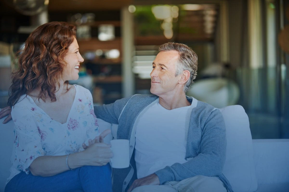 Mature couple engaging in an open and loving conversation, supported by the guidance of the save my marriage program from Marriage Helper.